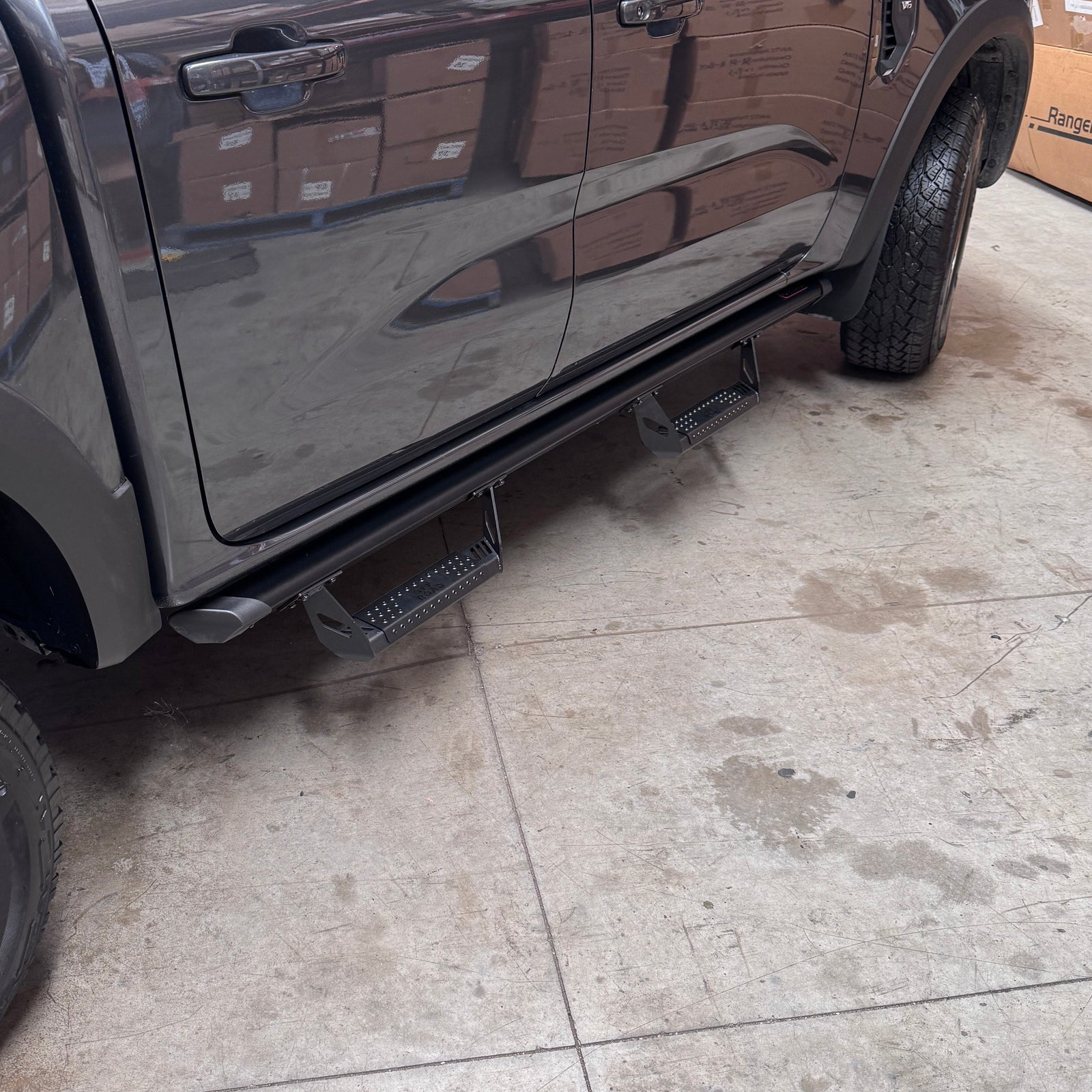 ANTZ Street Steps with military-style steps on a common rail mounted to a Next Gen Ford Ranger